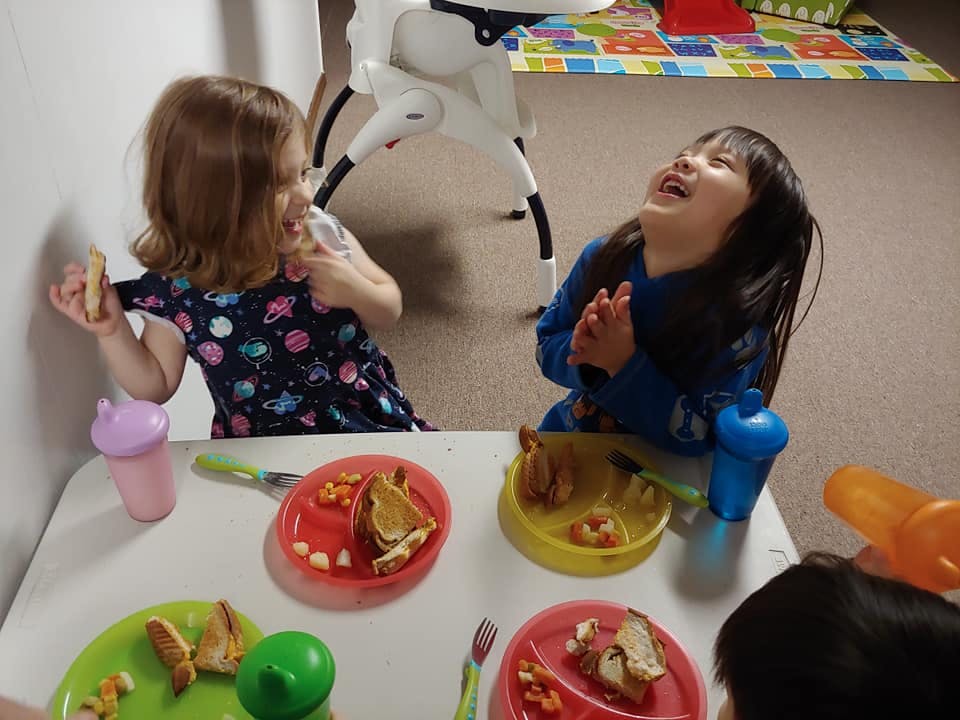Two children eating at a table