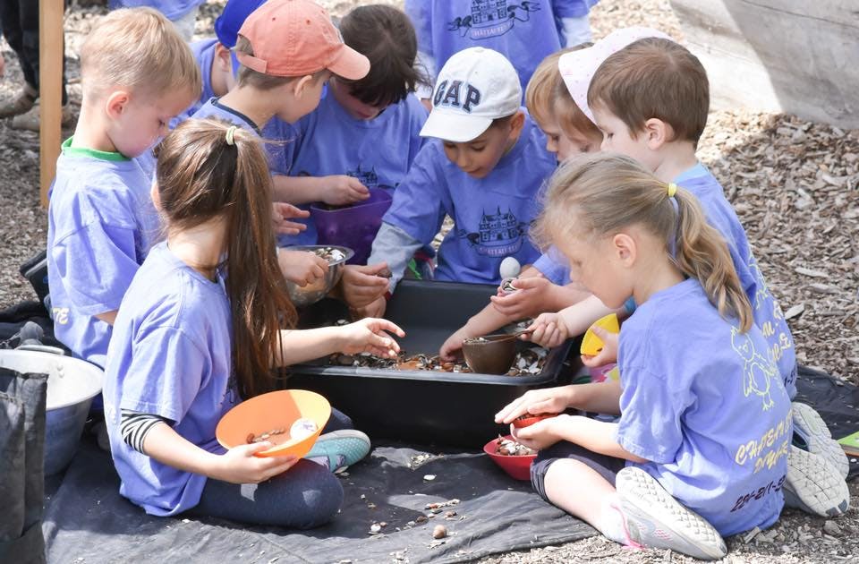 Children playing with dirt and small containers