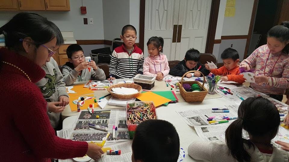 People and children crafting at a table