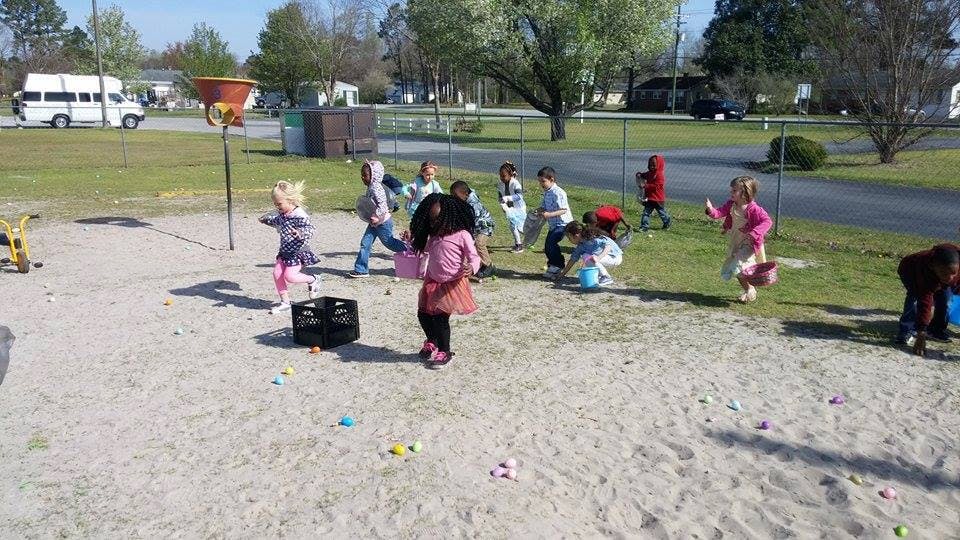 Children playing outdoors in a sandy area