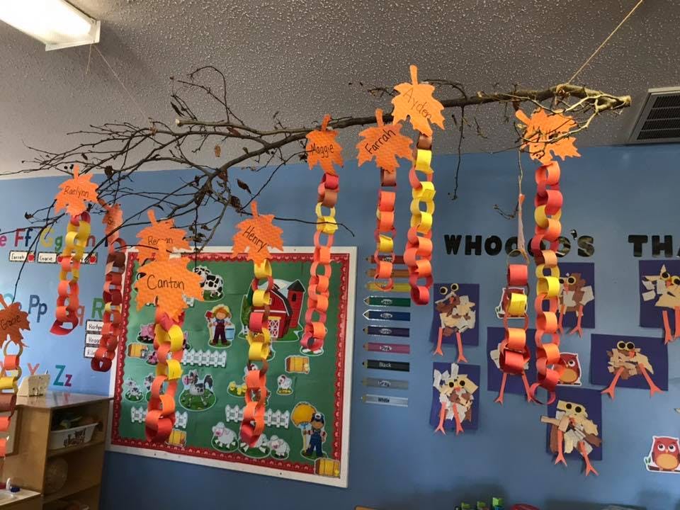 Classroom decorated with paper chains and cut-out leaves hanging from a branch