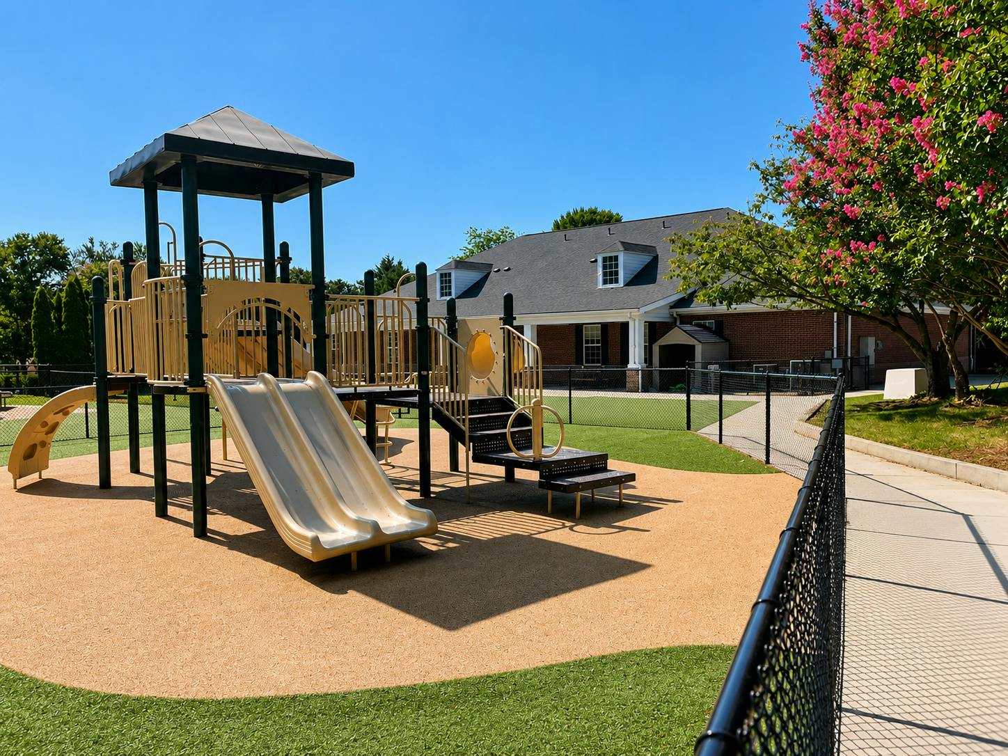 Playground equipment with a slide in a fenced yard