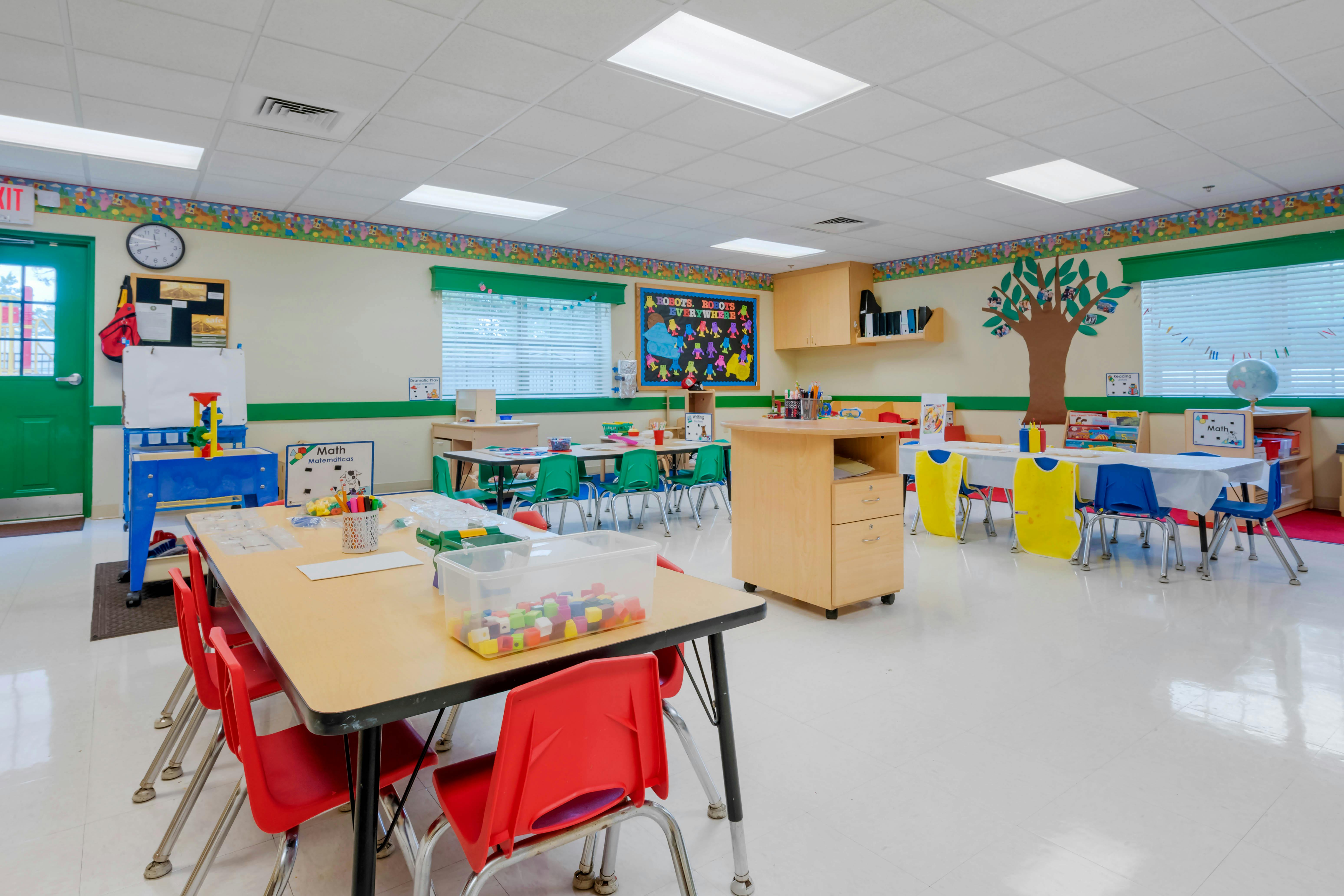 A colorful classroom with child-sized tables and chairs