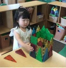 Child playing with colorful magnetic building blocks