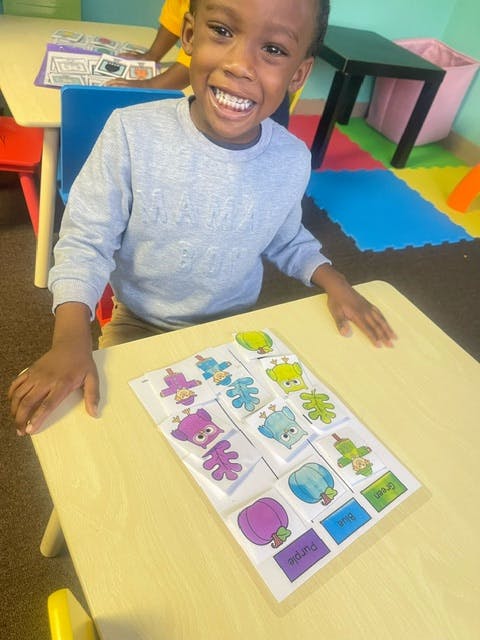 Child at a table with a learning activity
