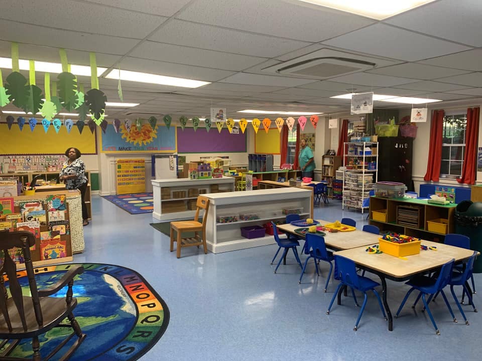 Classroom with tables, chairs, and learning materials
