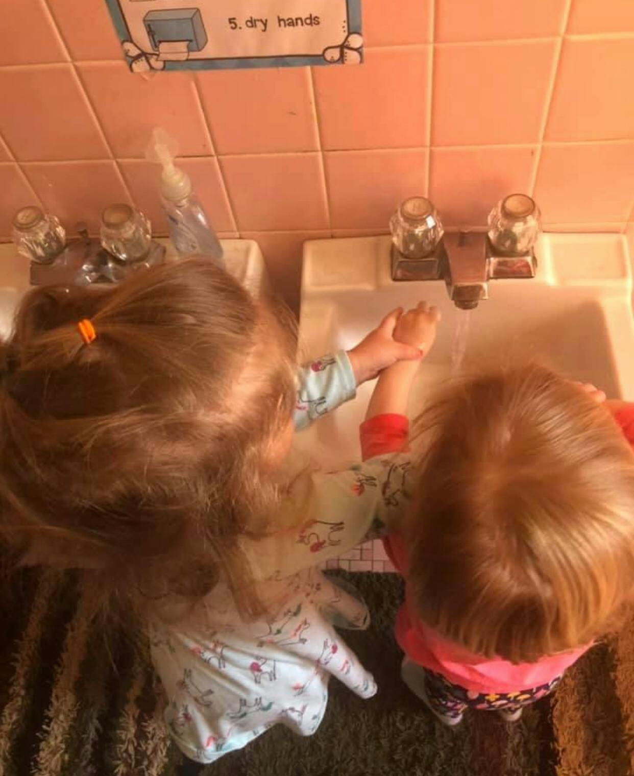 Two children washing hands at sinks