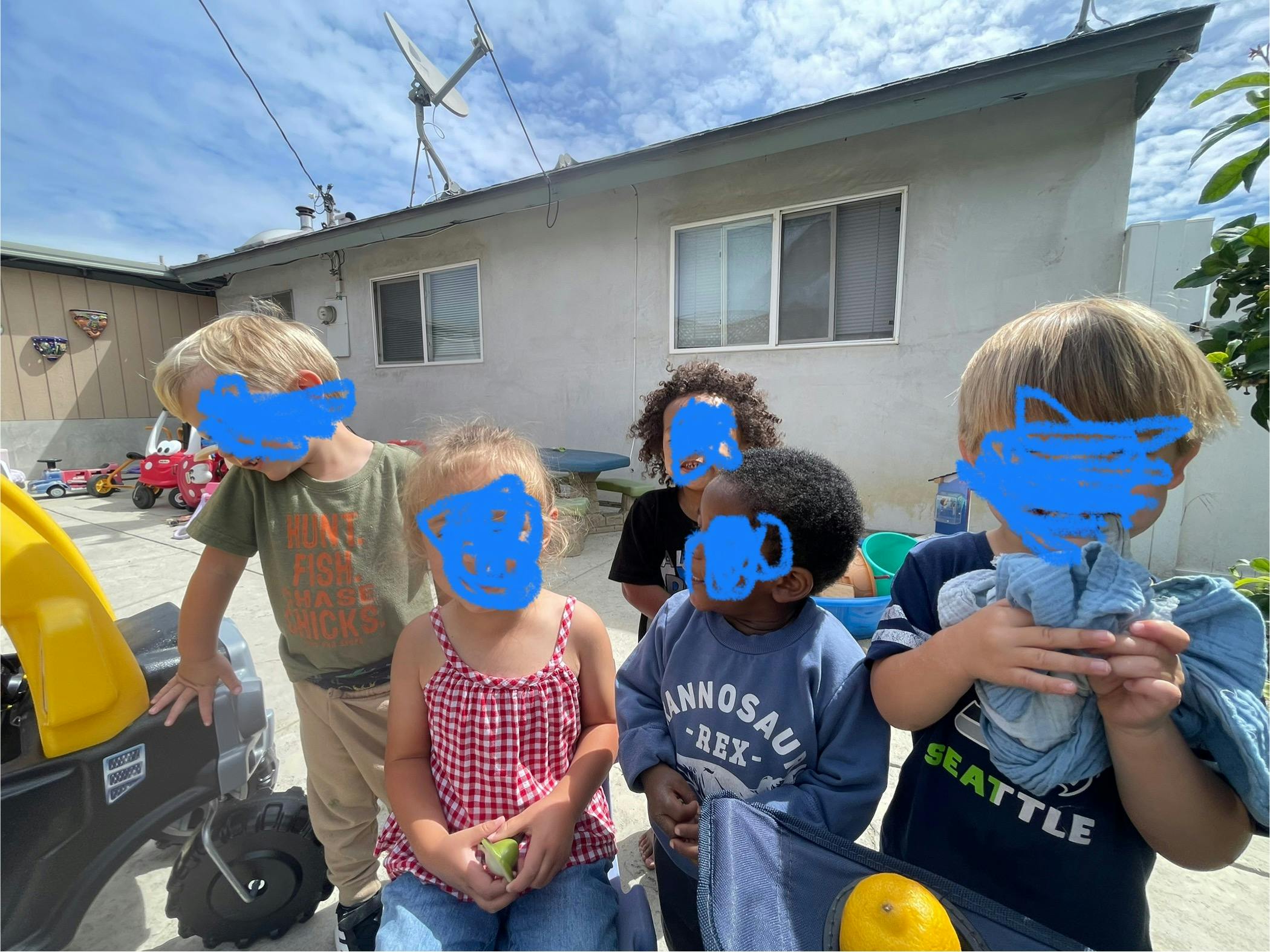 Group of children standing outdoors near a house