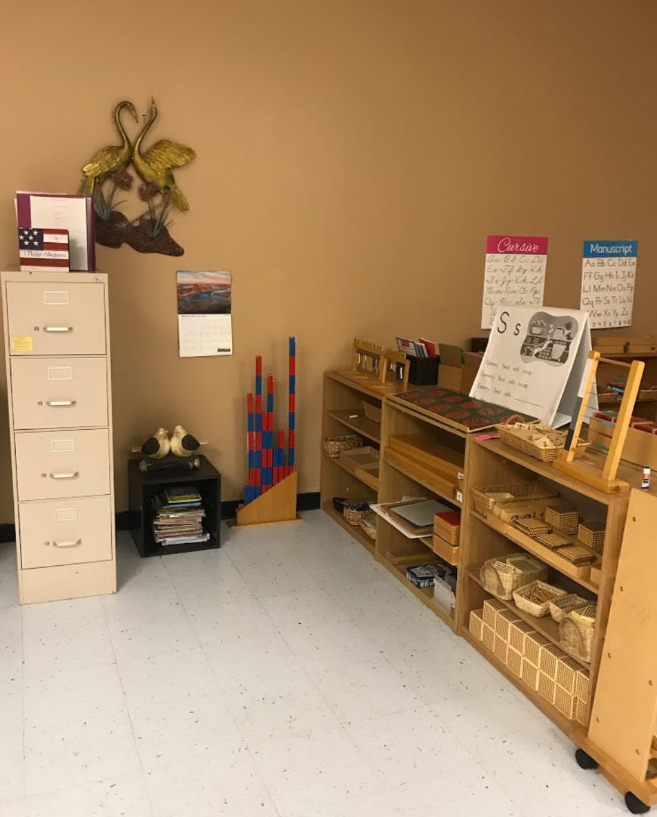 Classroom with filing cabinet, shelves, and learning materials