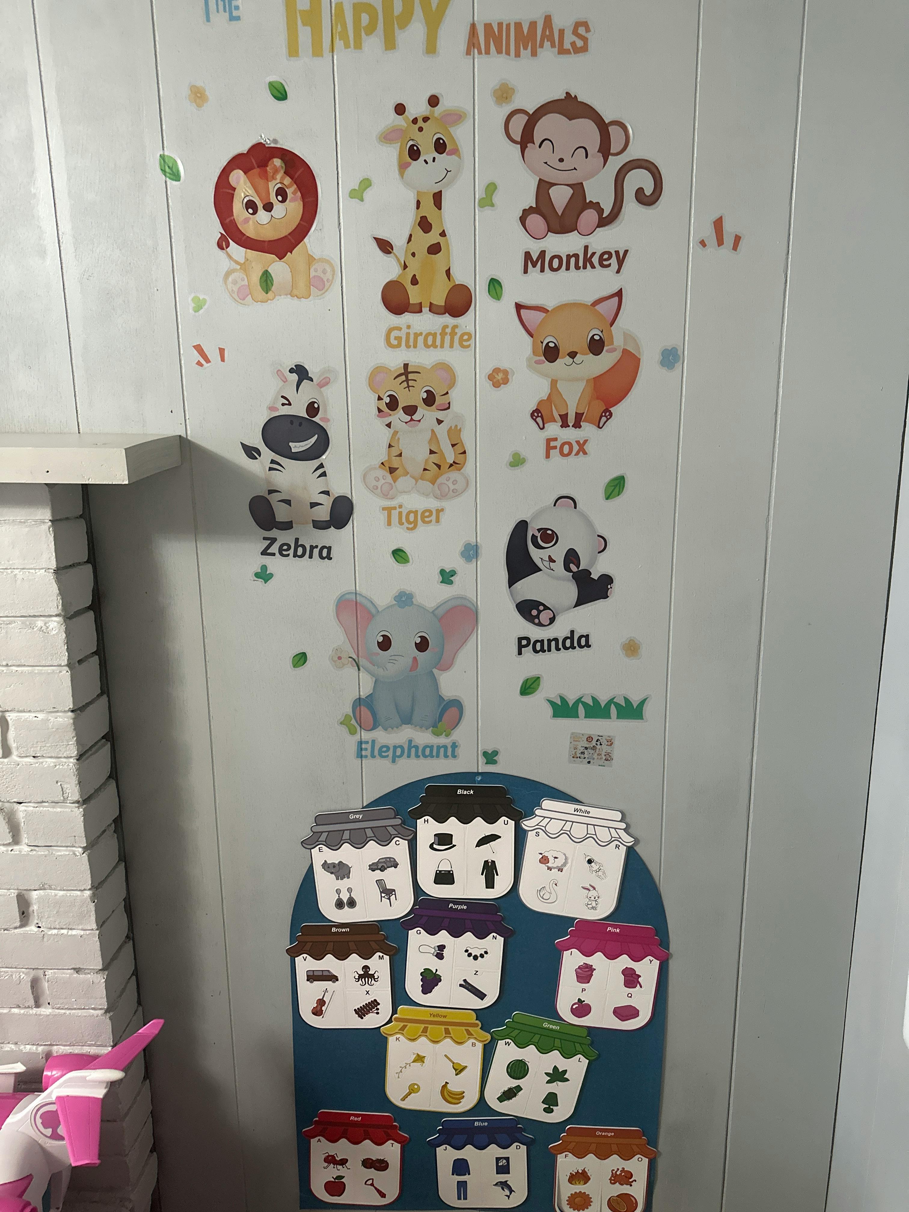 Wall decals of cartoon animals with names and a board with jar-shaped cutouts