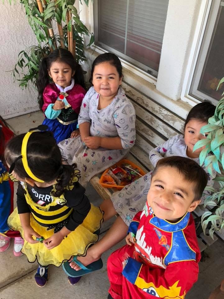 Children in costumes sitting together