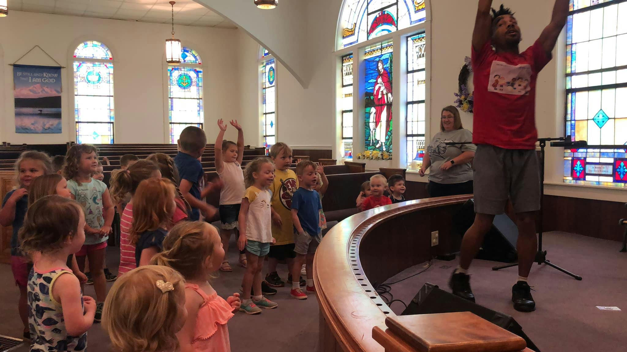 Adult leading a group of children in an activity