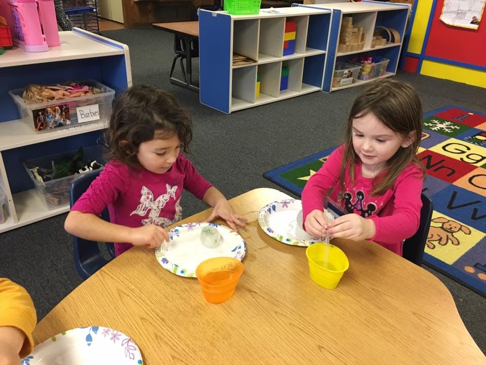 Two children at a table with plates and cups