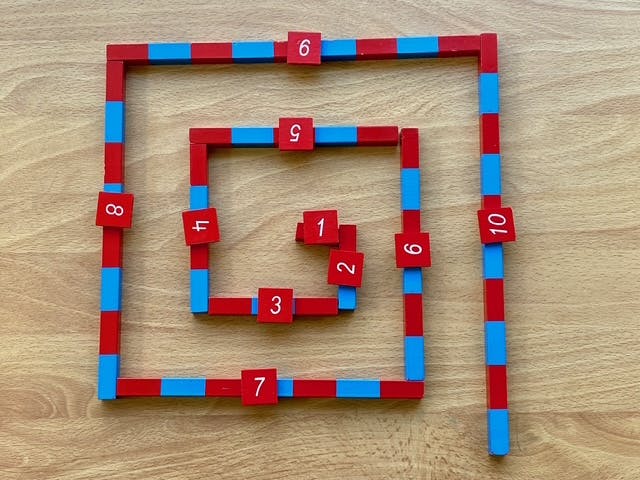 Red and blue counting blocks forming a spiral with numbers 1-10