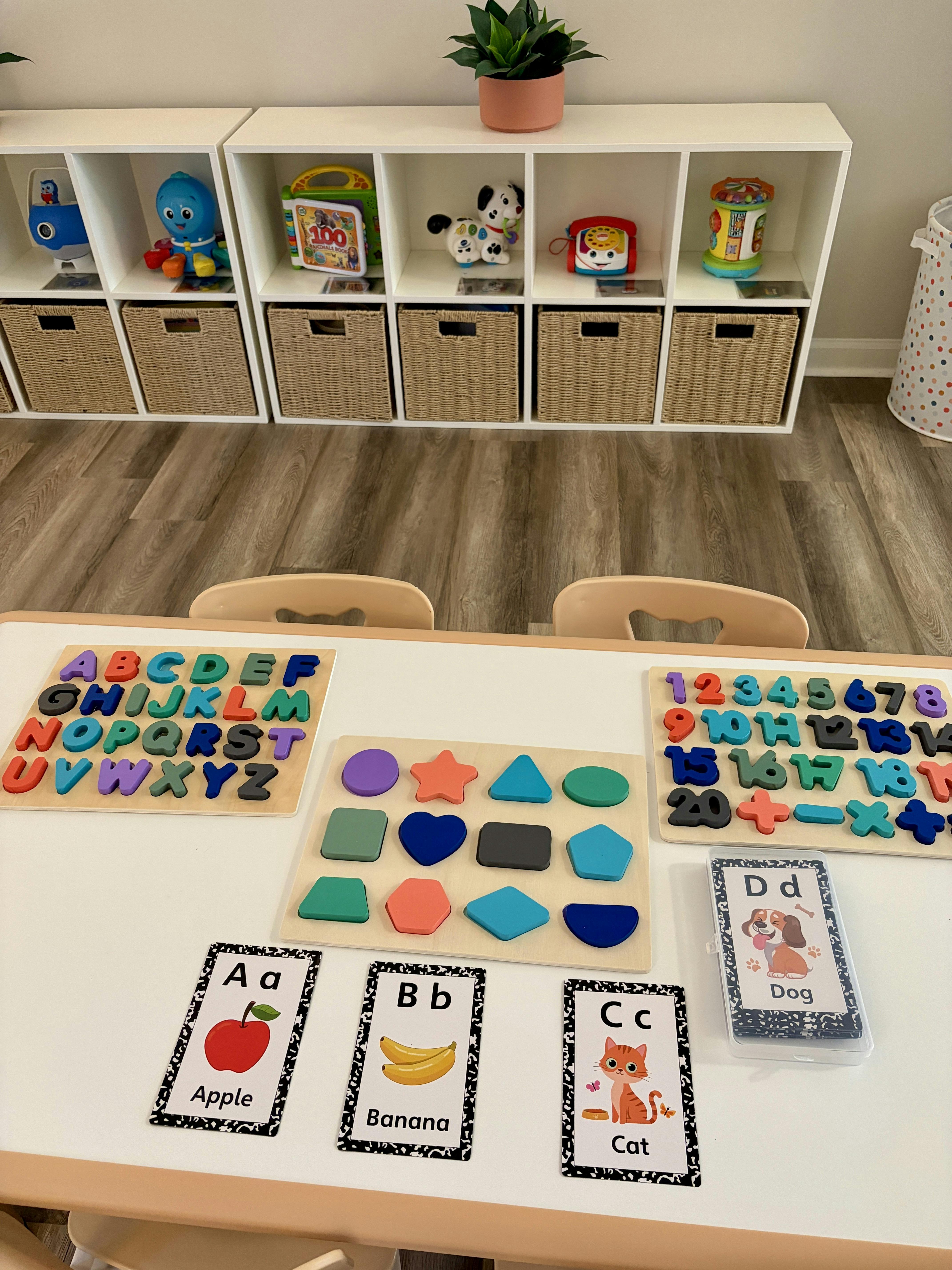 Educational toys and letter flashcards on a child-sized table