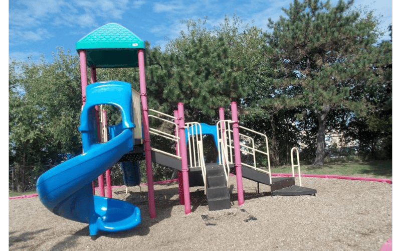 A colorful playground with slides and steps on a sunny day
