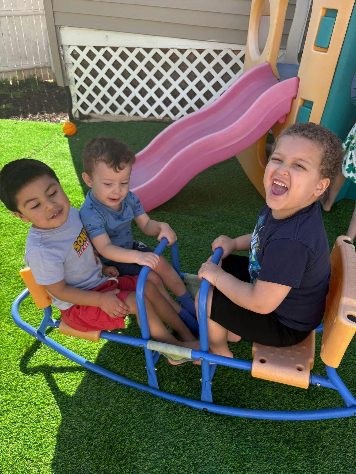 Three children playing on a see-saw