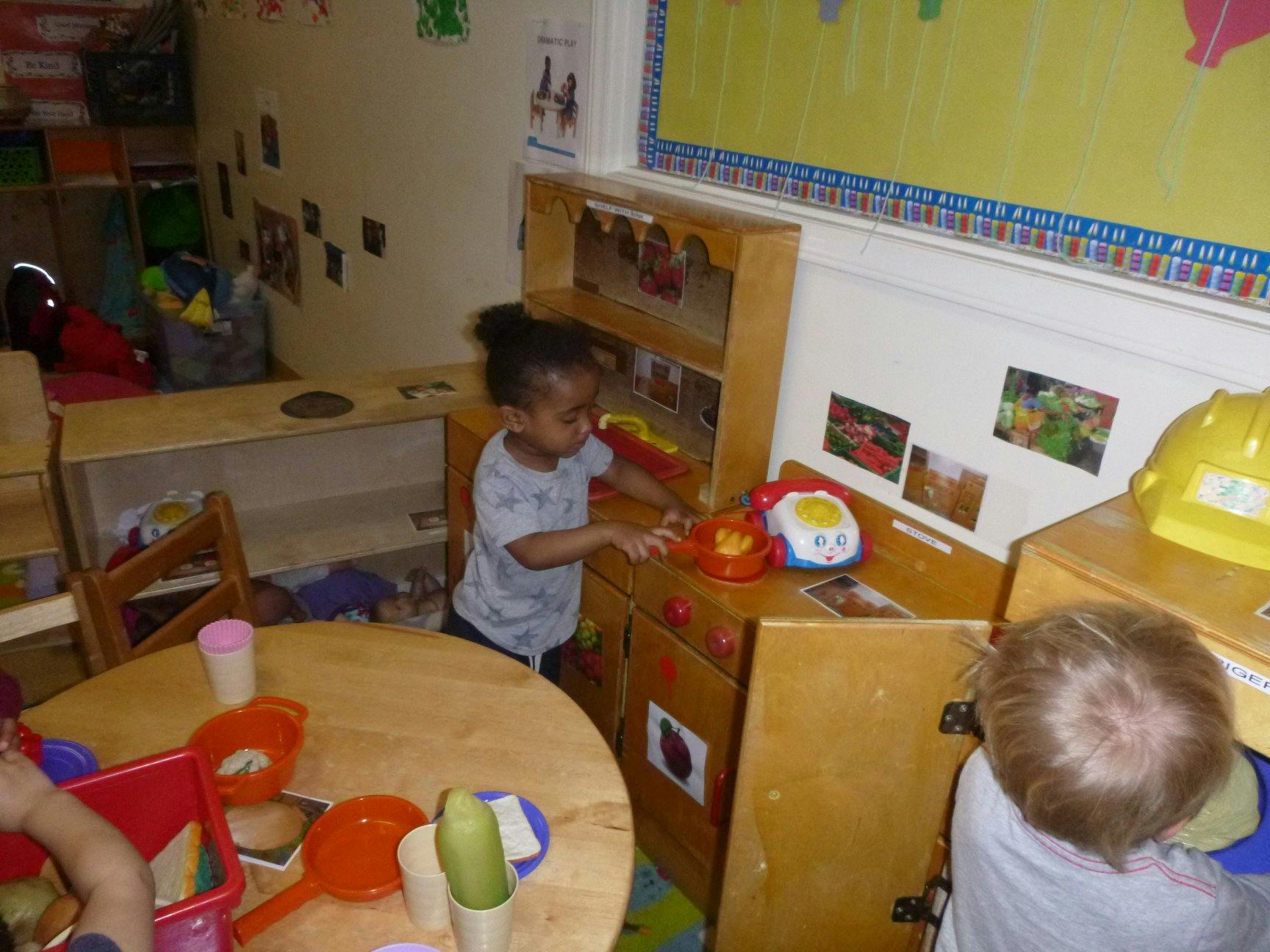 Child playing with toys in a classroom