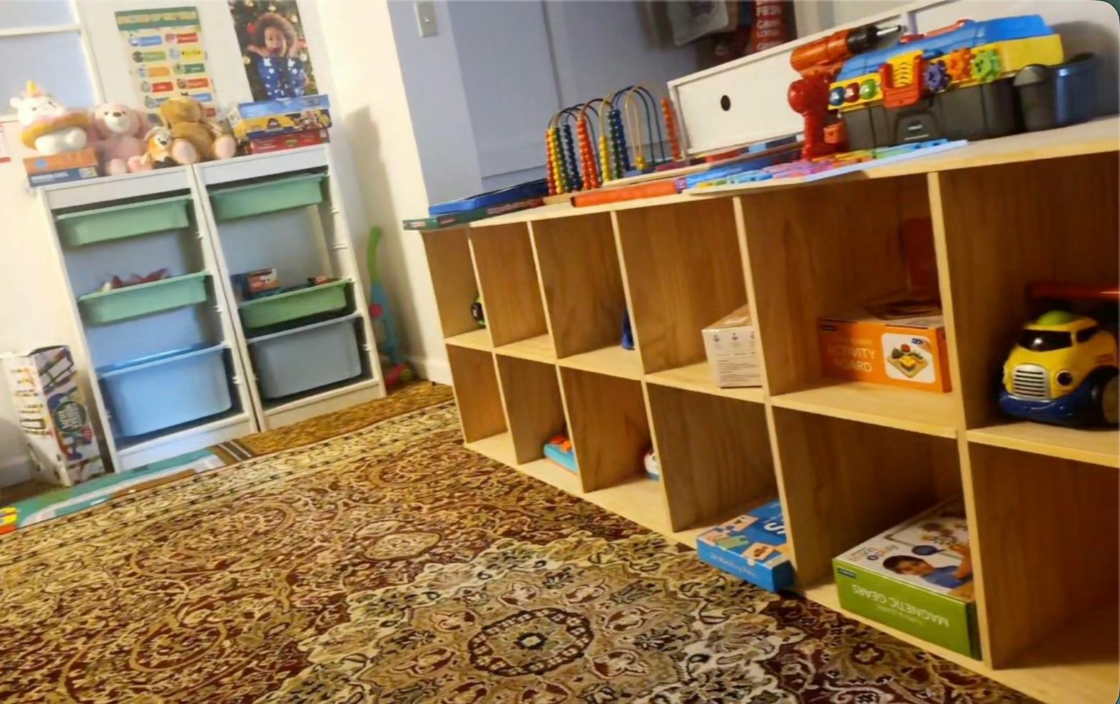 Wooden shelving units filled with various toys in a play area