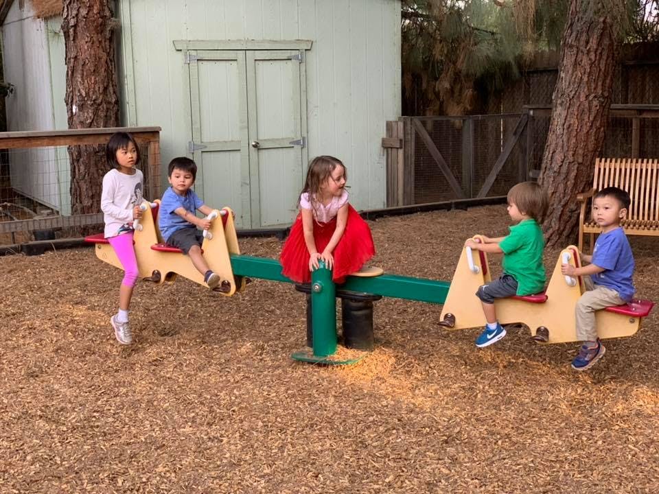 Children playing on a seesaw on a playground
