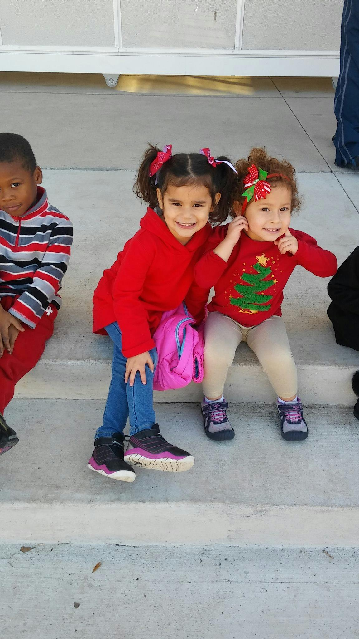 Three children sitting on steps