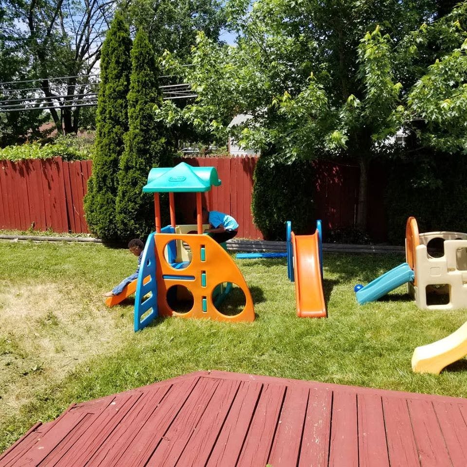 Outdoor playground with multiple slides and play structures on grass