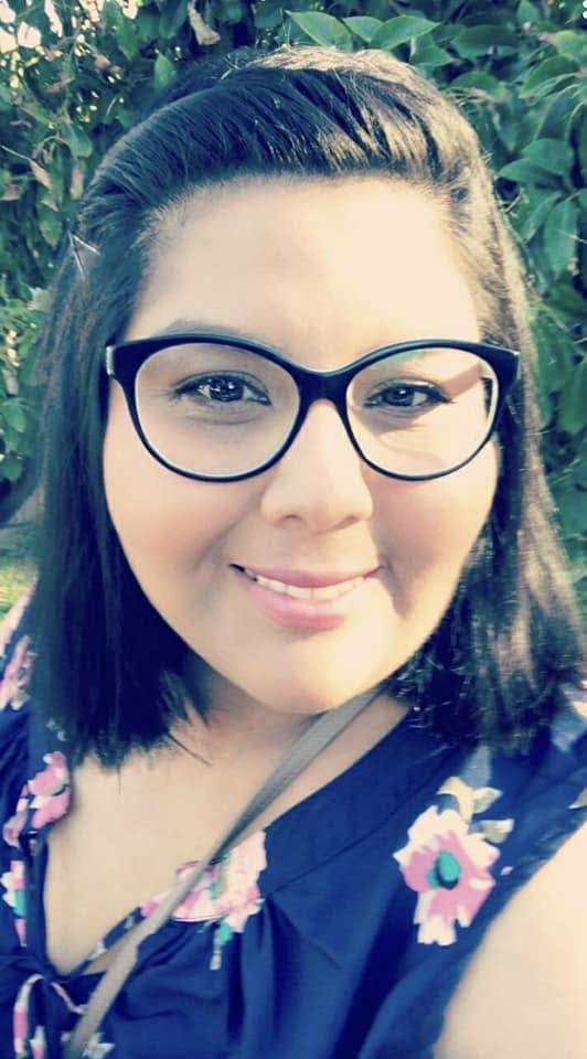 Person wearing glasses and a floral top