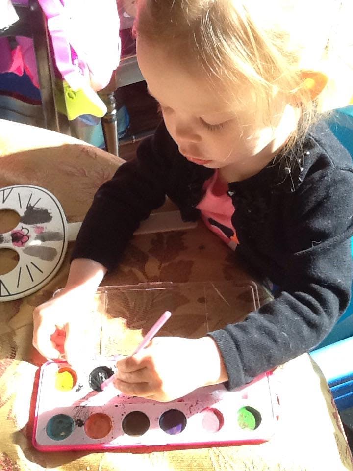 Child painting with watercolors