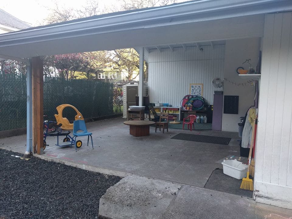 Covered patio with children's toys and outdoor furniture