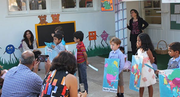Adults and children gathered in a classroom