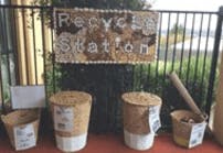 Recycle Station sign above four recycling bins