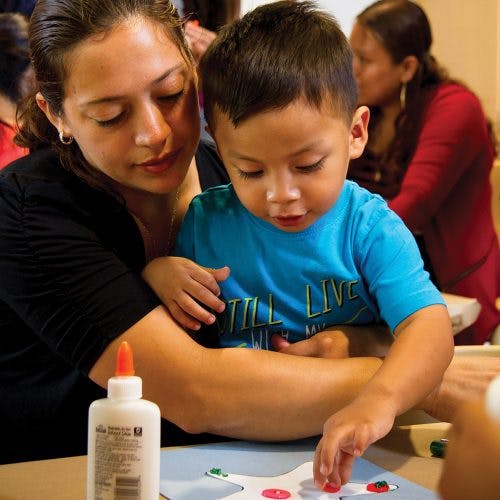 Adult and child doing a craft together