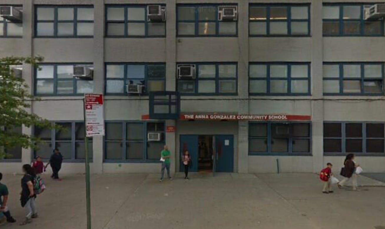 Building with multiple windows and people walking outside