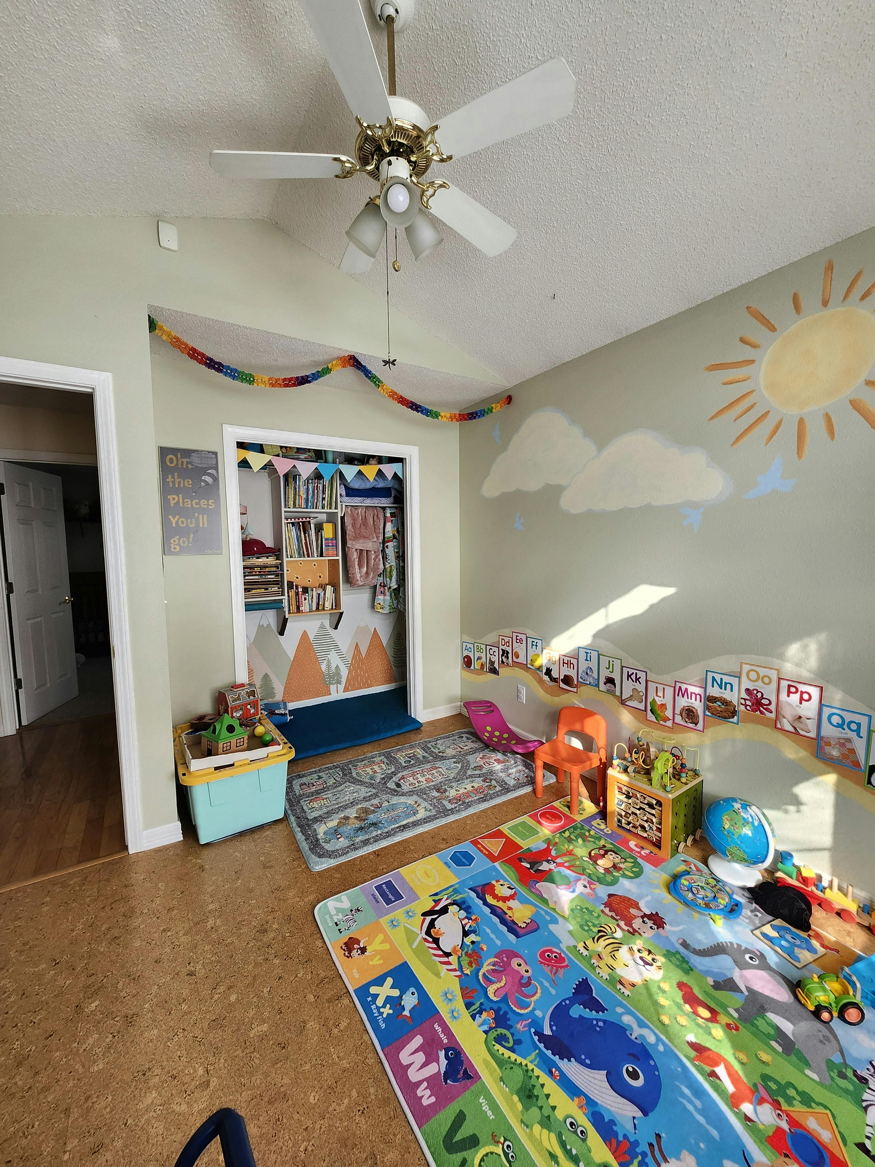 Playroom with colorful rugs, toys, and wall decorations