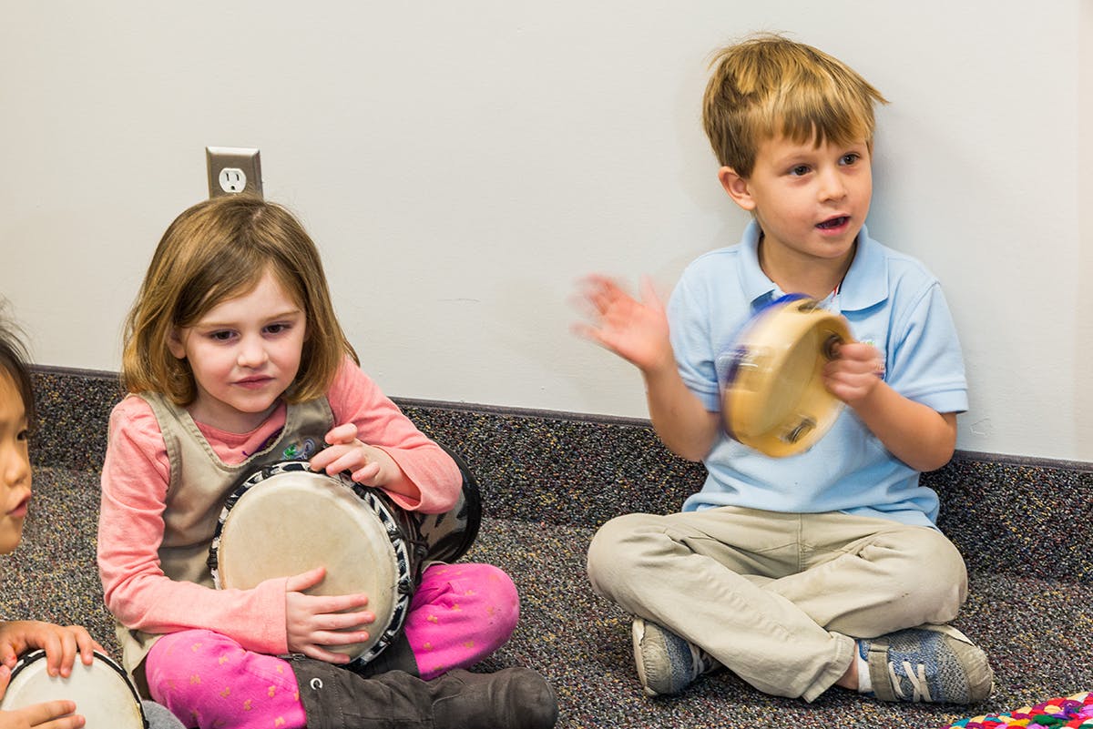 Two children playing musical instruments