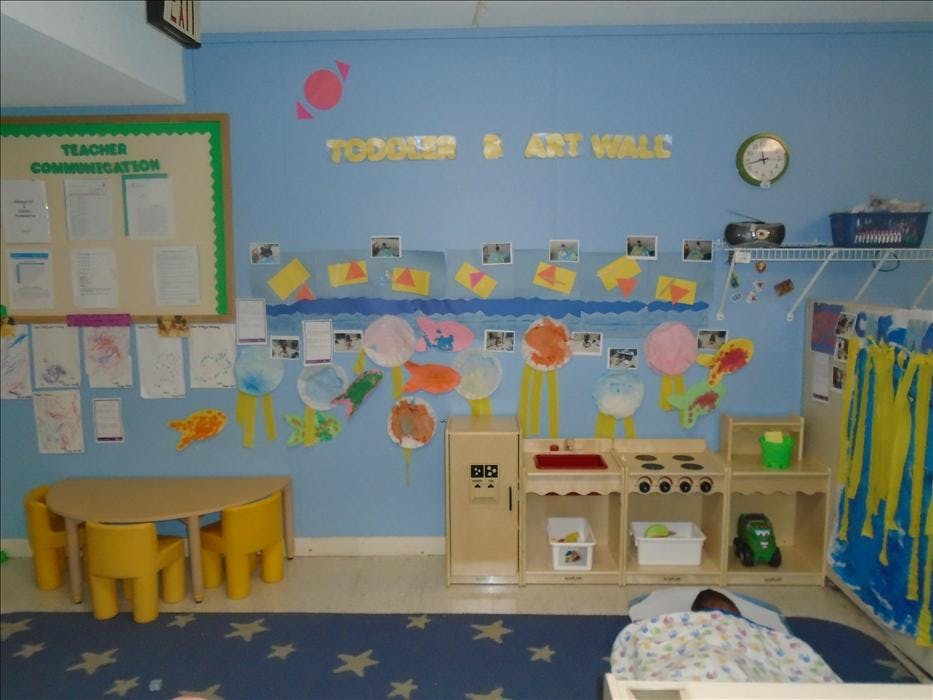 Classroom with child-sized furniture and artwork on the walls