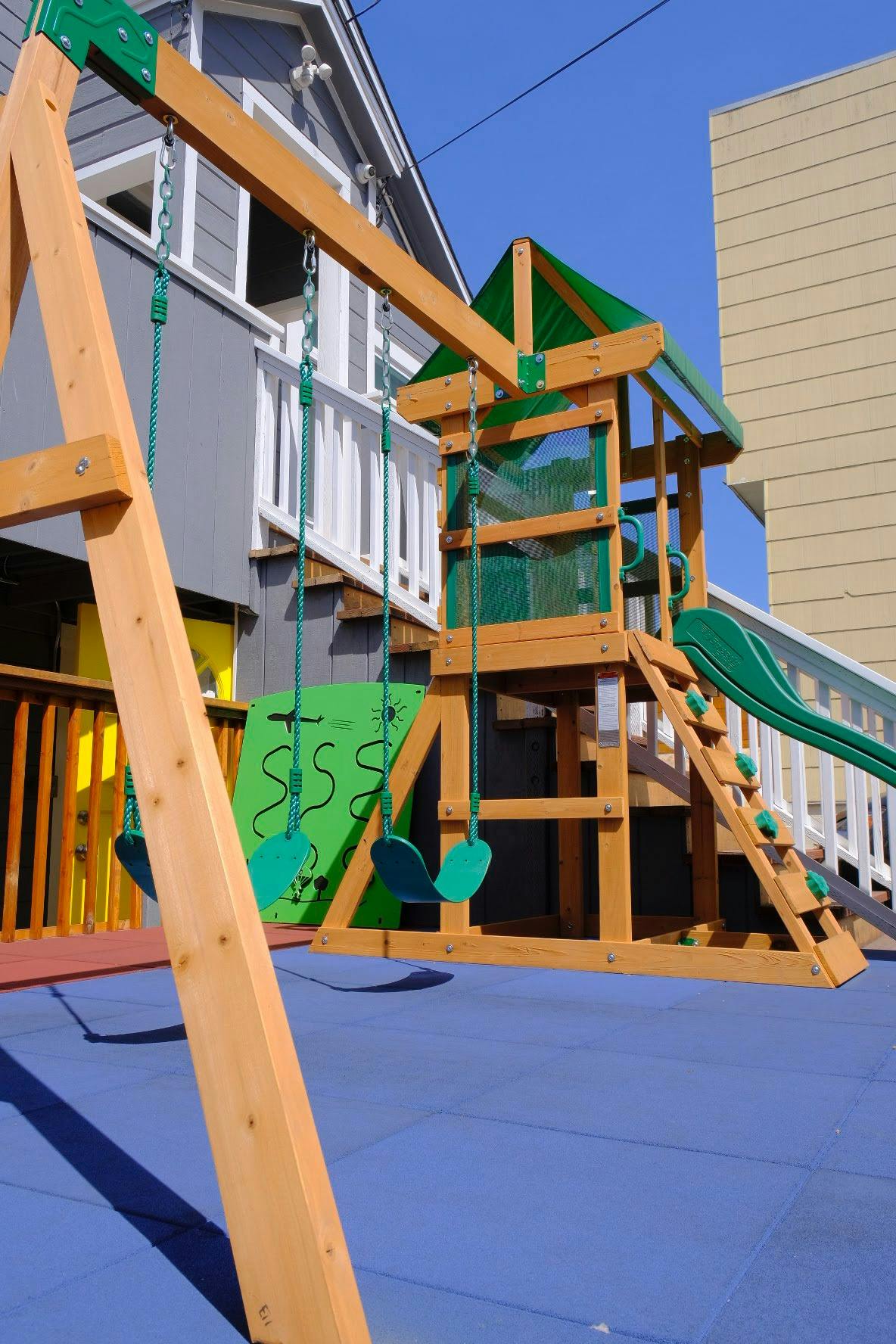 Wooden swing set and play structure with a slide
