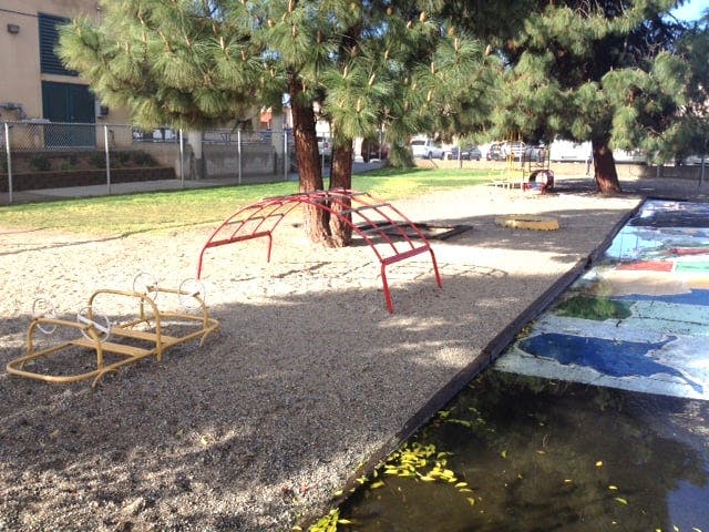 Playground with climbing structures and a painted map on the ground