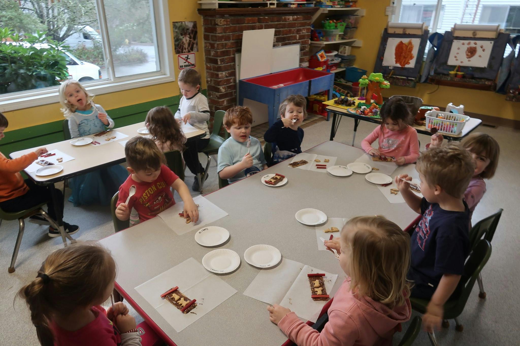 Children sitting at tables in a classroom