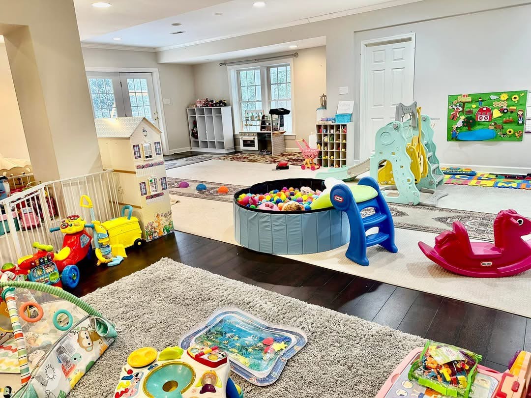 Indoor play area with a ball pit, slide, and various toys