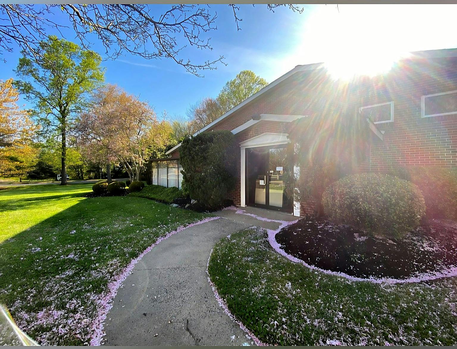 Brick building with a paved walkway leading to the entrance