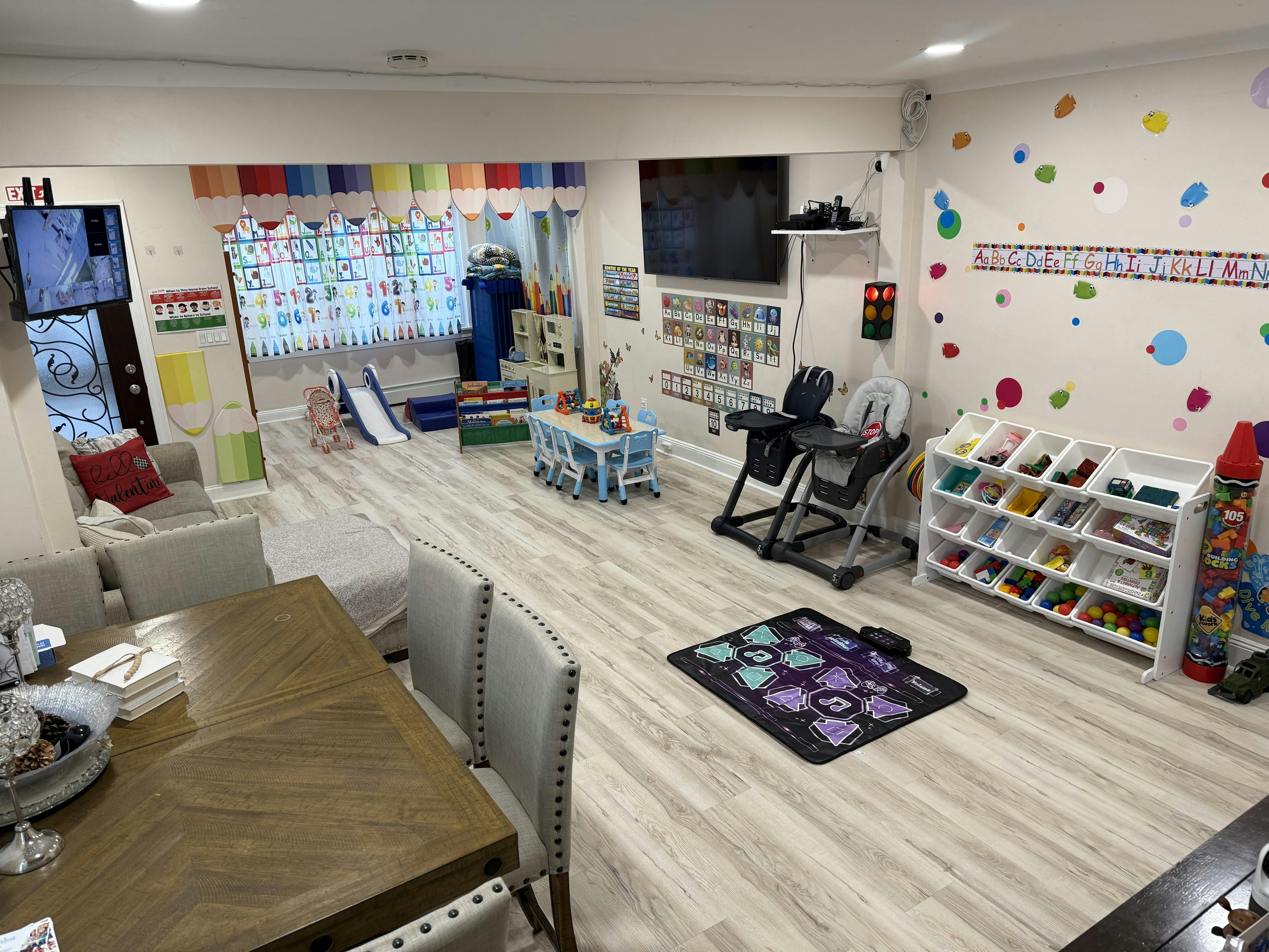 Playroom with various toys, small tables, and seating areas for children
