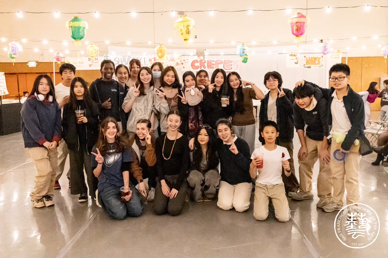 Many teens and children posing with drinks, some making peace signs