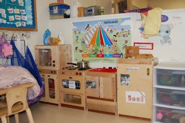 Children's play kitchen with wooden appliances and plastic appliances