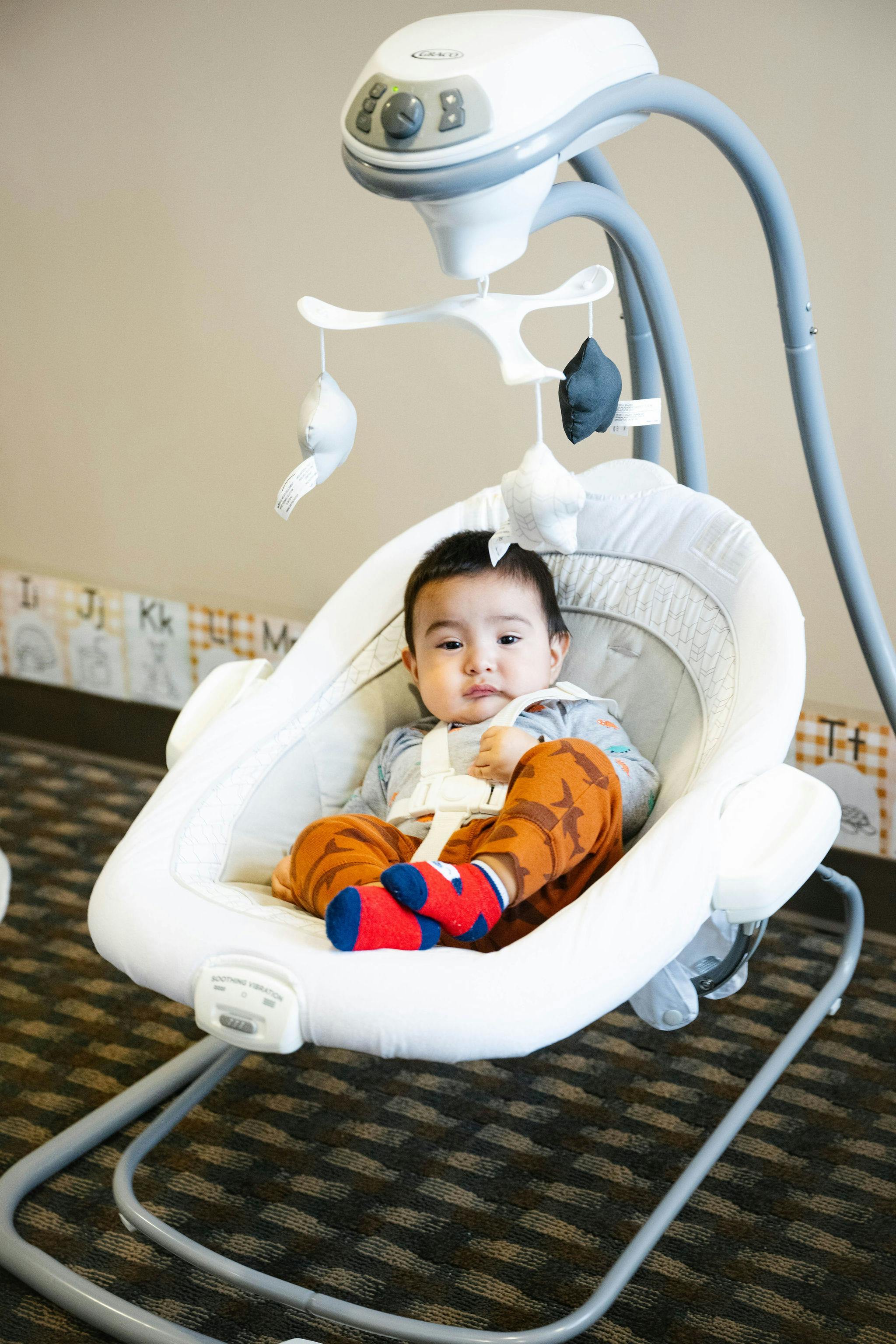 Child sitting in a baby swing