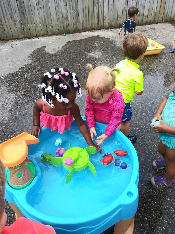 Children playing with a water table outdoors