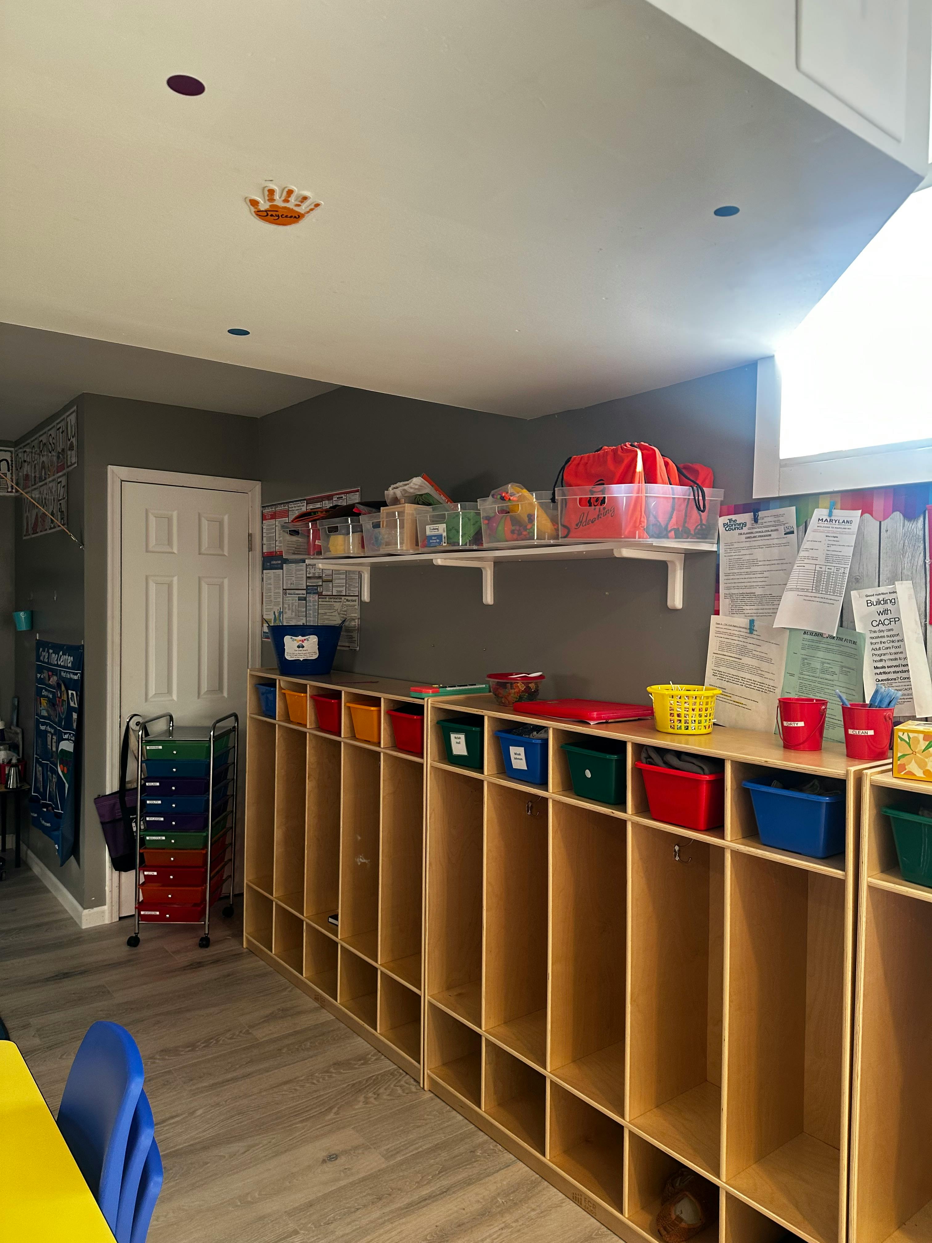 Classroom with cubbies and shelves holding bins