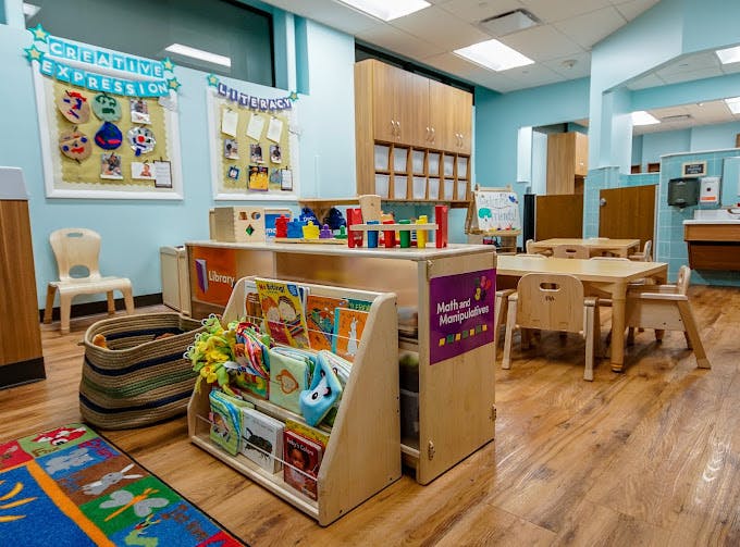 Children's classroom with books, toys, tables, and chairs