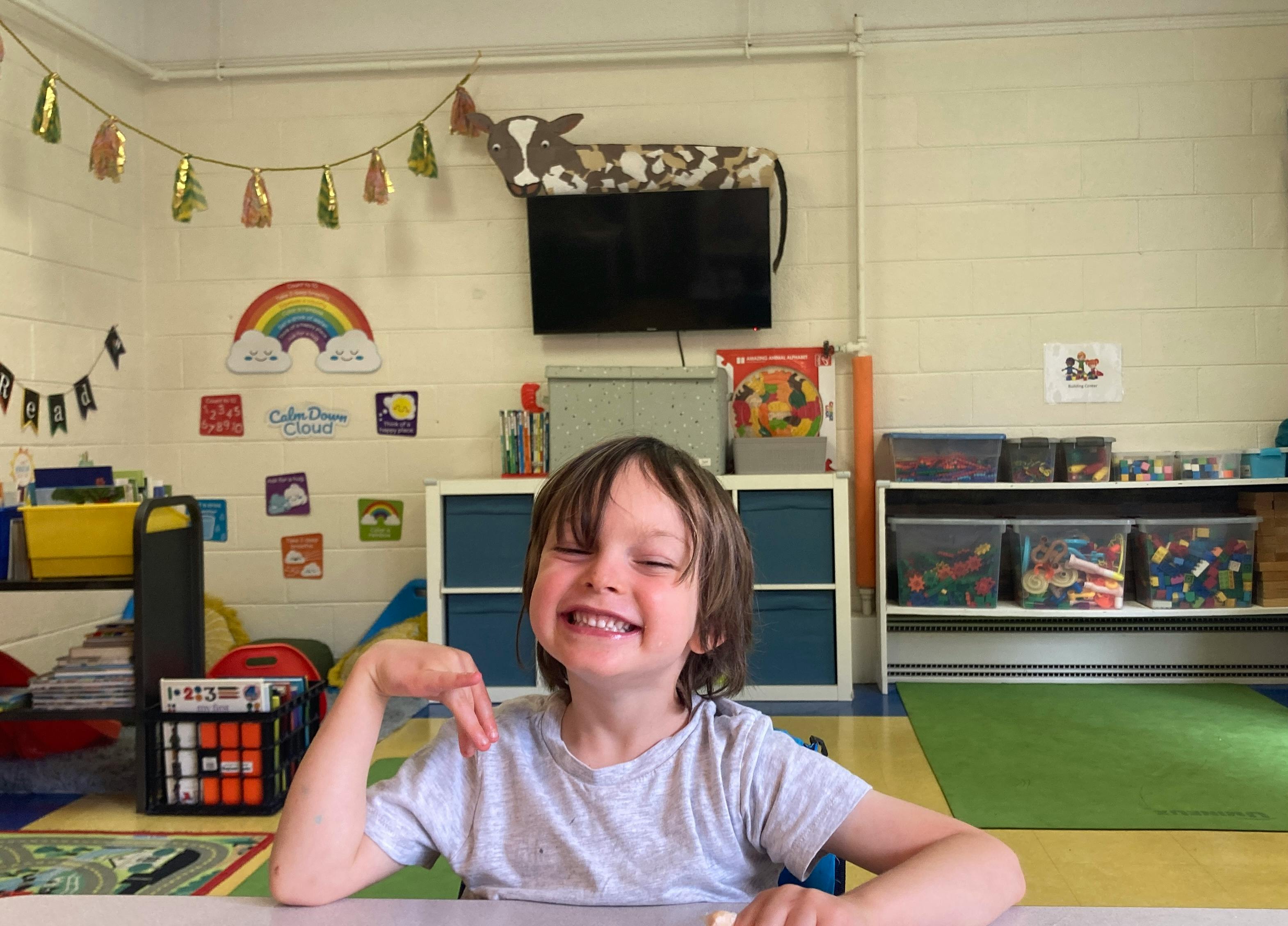 Child smiling in a classroom