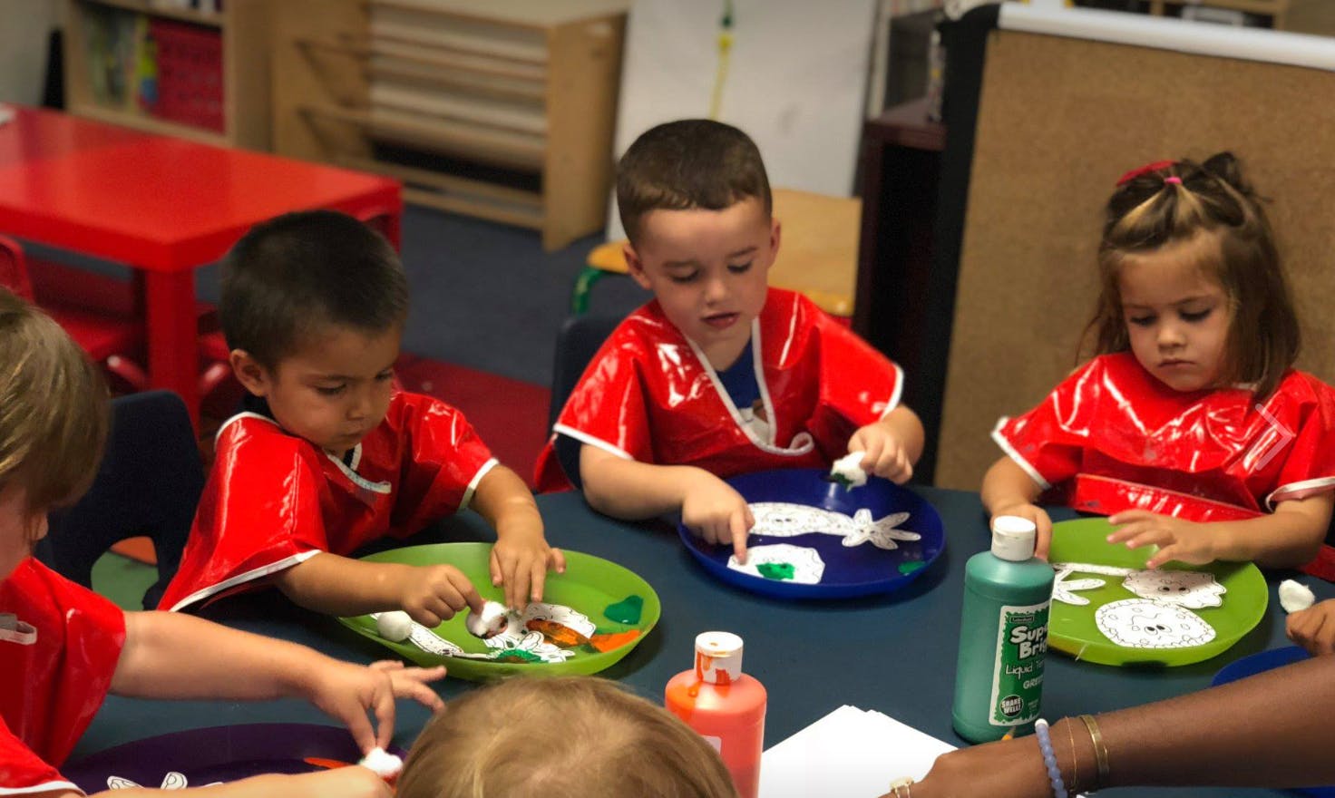 Children painting in a classroom